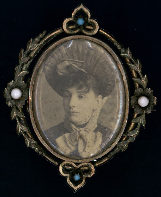 Brooch with picture of woman.